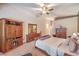 Spacious main bedroom featuring a ceiling fan, ensuite access, and classic wood furniture at 1145 Glacier Park Ct, Henderson, NV 89052