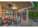 Covered outdoor patio seating area with patio heater, umbrella, and views of the landscaped backyard at 1145 Glacier Park Ct, Henderson, NV 89052