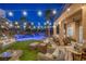 Lush backyard with a pool, waterfall feature, and a covered patio with seating, perfect for outdoor entertaining at 1246 Diamond Valley St, Henderson, NV 89052