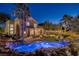 Stunning backyard oasis featuring a sparkling pool, lush landscaping, and cozy outdoor seating area at 1246 Diamond Valley St, Henderson, NV 89052