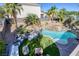 Overhead view of a backyard featuring a beautiful pool, rock waterfall, landscaping, and patio furniture at 1246 Diamond Valley St, Henderson, NV 89052