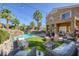 Lush backyard with a pool, rock waterfall, ambient lighting, and comfortable outdoor seating, ideal for entertaining at 1246 Diamond Valley St, Henderson, NV 89052