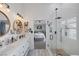 Bright bathroom featuring dual vanity, a walk-in shower, and a view into the bedroom at 1246 Diamond Valley St, Henderson, NV 89052