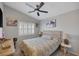 Neutral bedroom with patterned bedding, ceiling fan, shuttered windows and artistic decor at 1246 Diamond Valley St, Henderson, NV 89052