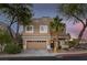 Charming two-story home with a well-maintained lawn, desert landscaping, and attached two-car garage at 1246 Diamond Valley St, Henderson, NV 89052
