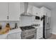 Modern kitchen featuring stainless steel appliances, white cabinets, and subway tile backsplash at 1246 Diamond Valley St, Henderson, NV 89052