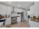 Well-lit kitchen with stainless steel appliances, white cabinets and tile backsplash at 1246 Diamond Valley St, Henderson, NV 89052