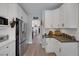 Bright kitchen with white cabinetry, stainless steel appliances, and hardwood flooring at 1246 Diamond Valley St, Henderson, NV 89052