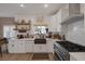 Modern kitchen with white cabinetry, farmhouse sink, and tile backsplash at 1246 Diamond Valley St, Henderson, NV 89052
