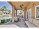 Cozy covered patio overlooking a backyard with a pool and waterfall, ideal for relaxation and outdoor dining at 1246 Diamond Valley St, Henderson, NV 89052