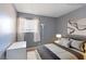 This bedroom features a neutral color scheme with a modern bed, rug, and sleek, minimalist decor at 1372 Lorilyn Ave # 3, Las Vegas, NV 89119