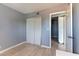 This bedroom features a neutral color scheme, gray walls, wood-look floors, and a sliding door closet at 1372 Lorilyn Ave # 3, Las Vegas, NV 89119