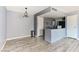 Open-concept kitchen with stone countertops, stainless steel appliances, and a dining area at 1372 Lorilyn Ave # 3, Las Vegas, NV 89119
