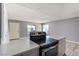 Open kitchen featuring island with stone countertops, stainless steel appliances, and tile flooring at 1372 Lorilyn Ave # 3, Las Vegas, NV 89119