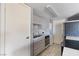 Efficient kitchen with sleek countertops, modern appliances, and a conveniently located washer/dryer unit at 1372 Lorilyn Ave # 3, Las Vegas, NV 89119