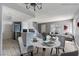 Open-concept living space with stylish dining set and a view of the modern kitchen at 1372 Lorilyn Ave # 3, Las Vegas, NV 89119