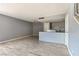 Spacious living area with wood-look tile floors and an open layout to the kitchen at 1372 Lorilyn Ave # 3, Las Vegas, NV 89119