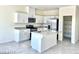 Modern kitchen with stainless steel appliances, a central island, and ample cabinet space at 1409 Gable Falls Pl # 89, North Las Vegas, NV 89084