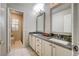 Bathroom showcasing a double sink vanity with modern fixtures and an open doorway to the toilet area at 1968 Evening Glow Dr, Las Vegas, NV 89134