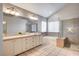 This bathroom boasts a shower, soaking tub, and and sinks with a large, mirrored vanity at 1968 Evening Glow Dr, Las Vegas, NV 89134