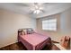 This bedroom features a comfortable bed, wood floors, and a view to the outdoors at 1968 Evening Glow Dr, Las Vegas, NV 89134