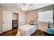 The bedroom features wood floors, a ceiling fan and a sliding door closet for storage at 1968 Evening Glow Dr, Las Vegas, NV 89134