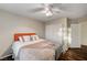 Comfortable bedroom features wood floors, a ceiling fan, and a window with blinds, creating a cozy atmosphere at 1968 Evening Glow Dr, Las Vegas, NV 89134