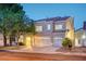 Charming two-story home with a three-car garage, well-manicured landscaping, and welcoming curb appeal at 1968 Evening Glow Dr, Las Vegas, NV 89134
