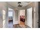 Hallway leading to bedrooms and bathrooms, featuring wood floors and a decorative archway for added charm at 1968 Evening Glow Dr, Las Vegas, NV 89134