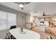 Bright kitchen and breakfast nook with white cabinets, stainless steel appliances and bar stool seating at 1968 Evening Glow Dr, Las Vegas, NV 89134