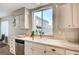 Bright kitchen featuring white countertops, stainless steel dishwasher, and large windows offering ample natural light at 1968 Evening Glow Dr, Las Vegas, NV 89134