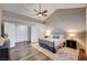 A spacious main bedroom is brightly lit, with a ceiling fan and a walk-in closet that offers plenty of storage space at 1968 Evening Glow Dr, Las Vegas, NV 89134