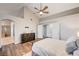 This bright main bedroom features wood floors, a ceiling fan, and an adjoining bathroom with a glass shower at 1968 Evening Glow Dr, Las Vegas, NV 89134