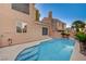 Beautiful backyard showcasing a refreshing pool with a spa, complemented by lush greenery and a tranquil ambiance at 1968 Evening Glow Dr, Las Vegas, NV 89134