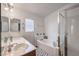 Well-lit bathroom with double sinks, a soaking tub, and a glass-enclosed shower at 2109 Mountain Sunset Ave, North Las Vegas, NV 89031