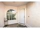 Cozy front porch featuring a decorative window and a neutral-colored entrance door at 2109 Mountain Sunset Ave, North Las Vegas, NV 89031
