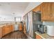 Another angle of the kitchen with stainless steel appliances, granite countertops, and wood cabinetry at 2109 Mountain Sunset Ave, North Las Vegas, NV 89031