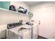 Efficient laundry room featuring modern appliances and ample storage space at 2109 Mountain Sunset Ave, North Las Vegas, NV 89031