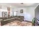 Comfortable living room with a large sectional, stylish rug, and a view into the kitchen at 2109 Mountain Sunset Ave, North Las Vegas, NV 89031