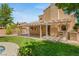 Spacious backyard with covered patio, outdoor kitchen, and well-manicured lawn, perfect for outdoor entertaining at 215 Sunlight Peak St, Henderson, NV 89012