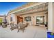 Covered back patio with ceiling fan, wood burning fireplace, and seating area for relaxing and enjoying the outdoors at 2150 Maple Heights Ct, Henderson, NV 89052