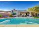 Backyard pool area with covered patio, seating, mature landscaping, and room for outdoor activities and entertaining at 2150 Maple Heights Ct, Henderson, NV 89052