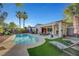 Expansive backyard pool with a covered patio area, beautiful landscaping, and lounge chairs for outdoor relaxation at 2150 Maple Heights Ct, Henderson, NV 89052