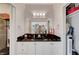 Bathroom with a large black granite countertop, white cabinetry, and ample storage at 2150 Maple Heights Ct, Henderson, NV 89052