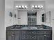 Bathroom featuring a gray vanity with dual sinks, marble countertop, and mirrored wall at 2150 Maple Heights Ct, Henderson, NV 89052