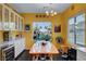 Bright dining area with large windows offering views, complemented by stylish décor and a cozy ambiance at 2150 Maple Heights Ct, Henderson, NV 89052