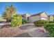 Single-story home boasts desert landscaping, enhancing the charm and low-maintenance appeal at 2150 Maple Heights Ct, Henderson, NV 89052