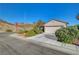 Charming single-story home features lush landscaping, a two-car garage, and desert surroundings at 2150 Maple Heights Ct, Henderson, NV 89052