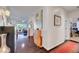 Beautiful hallway with dark hardwood floors leading to a bright living area and home office at 2150 Maple Heights Ct, Henderson, NV 89052
