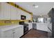Contemporary kitchen with stainless steel appliances, white cabinets, and ample counter space, designed for convenience and style at 2150 Maple Heights Ct, Henderson, NV 89052